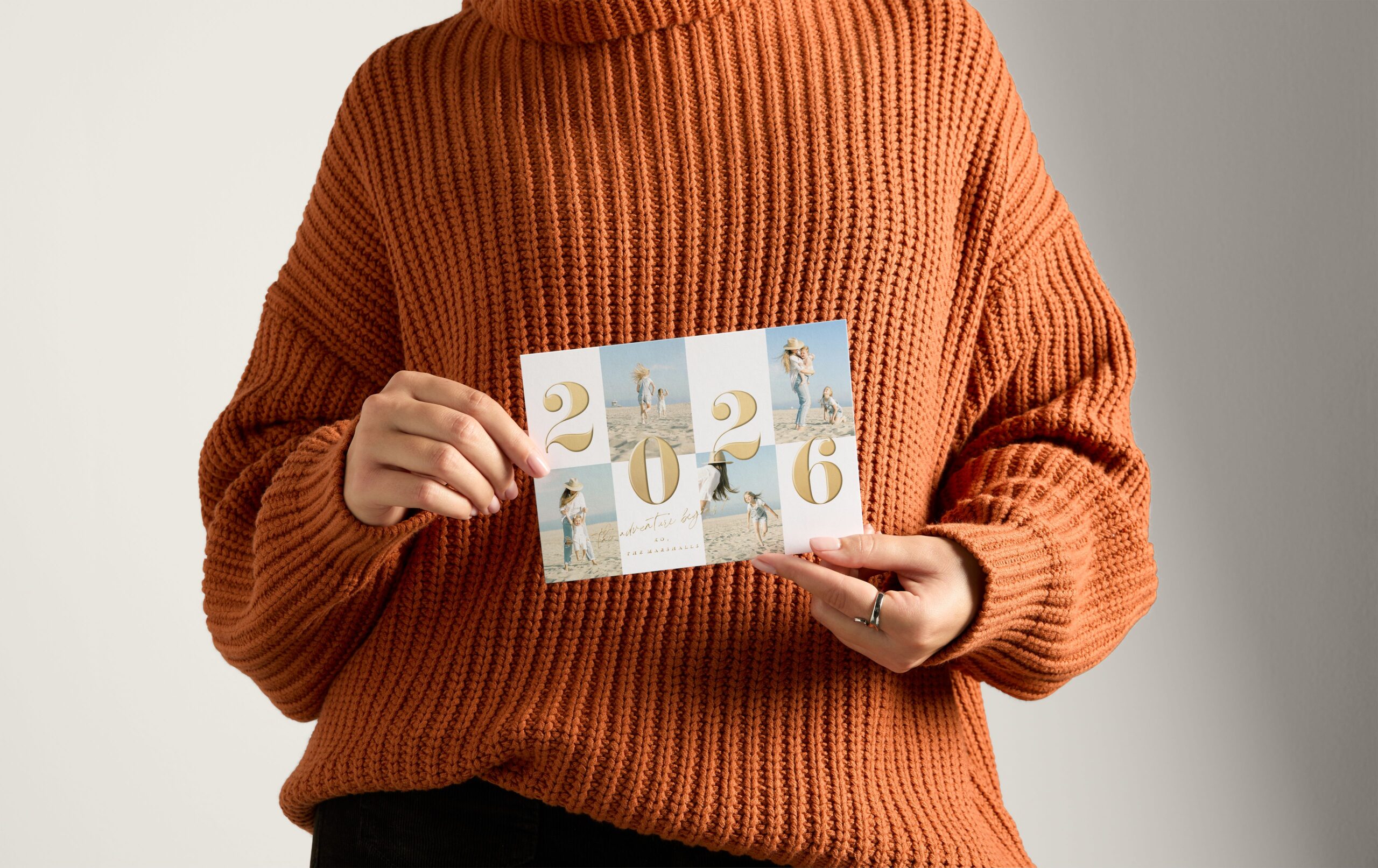 woman holding a 2026 happy new year card