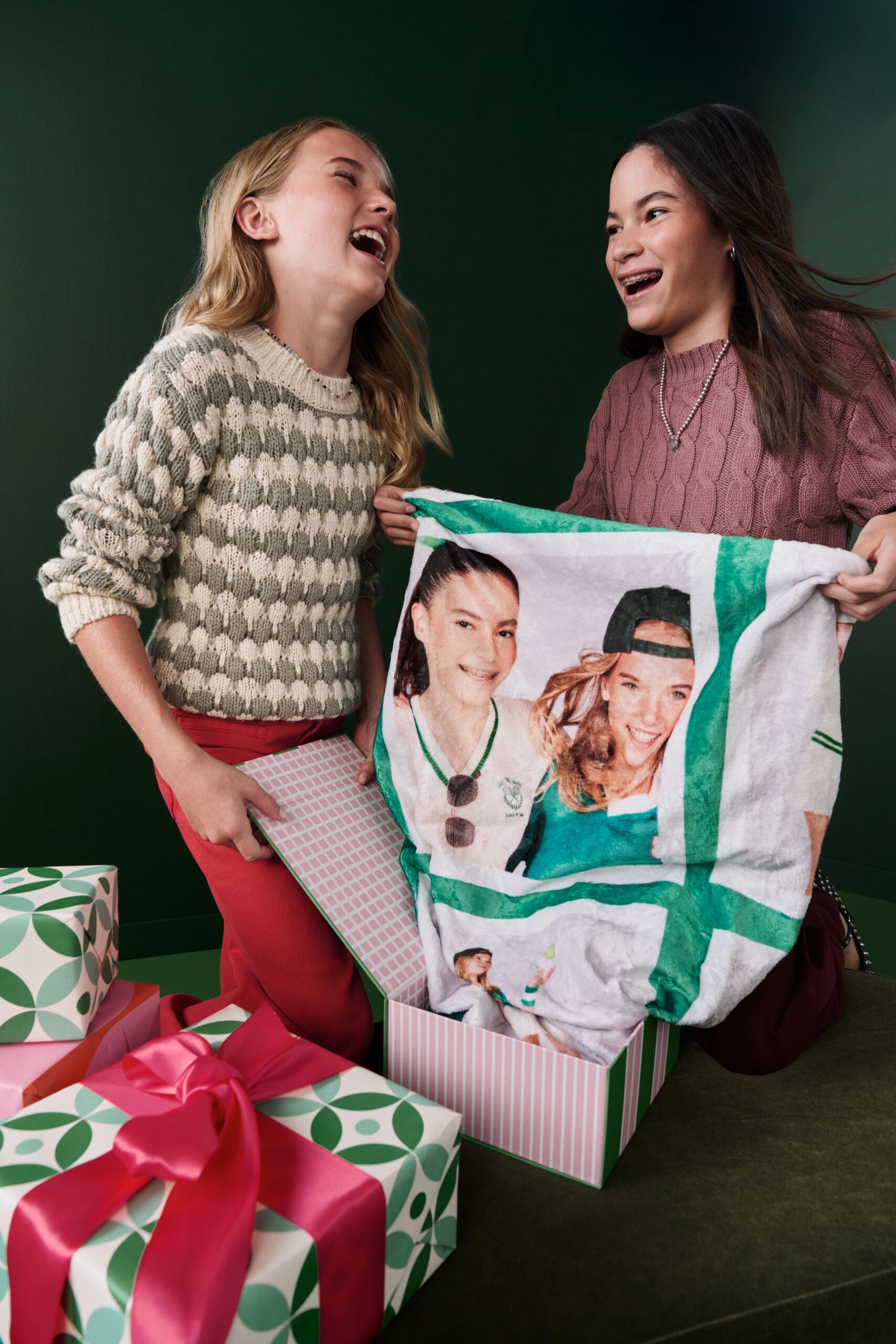 friends posing with fleece photo blanket with their picture
