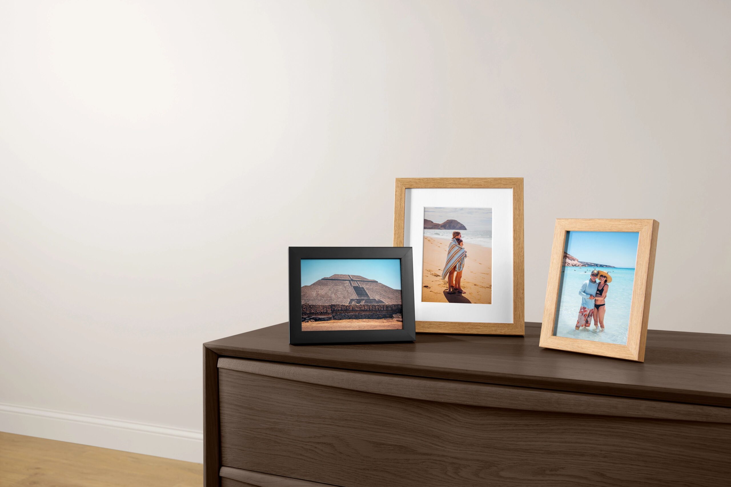 three tabletop prints on a dresser