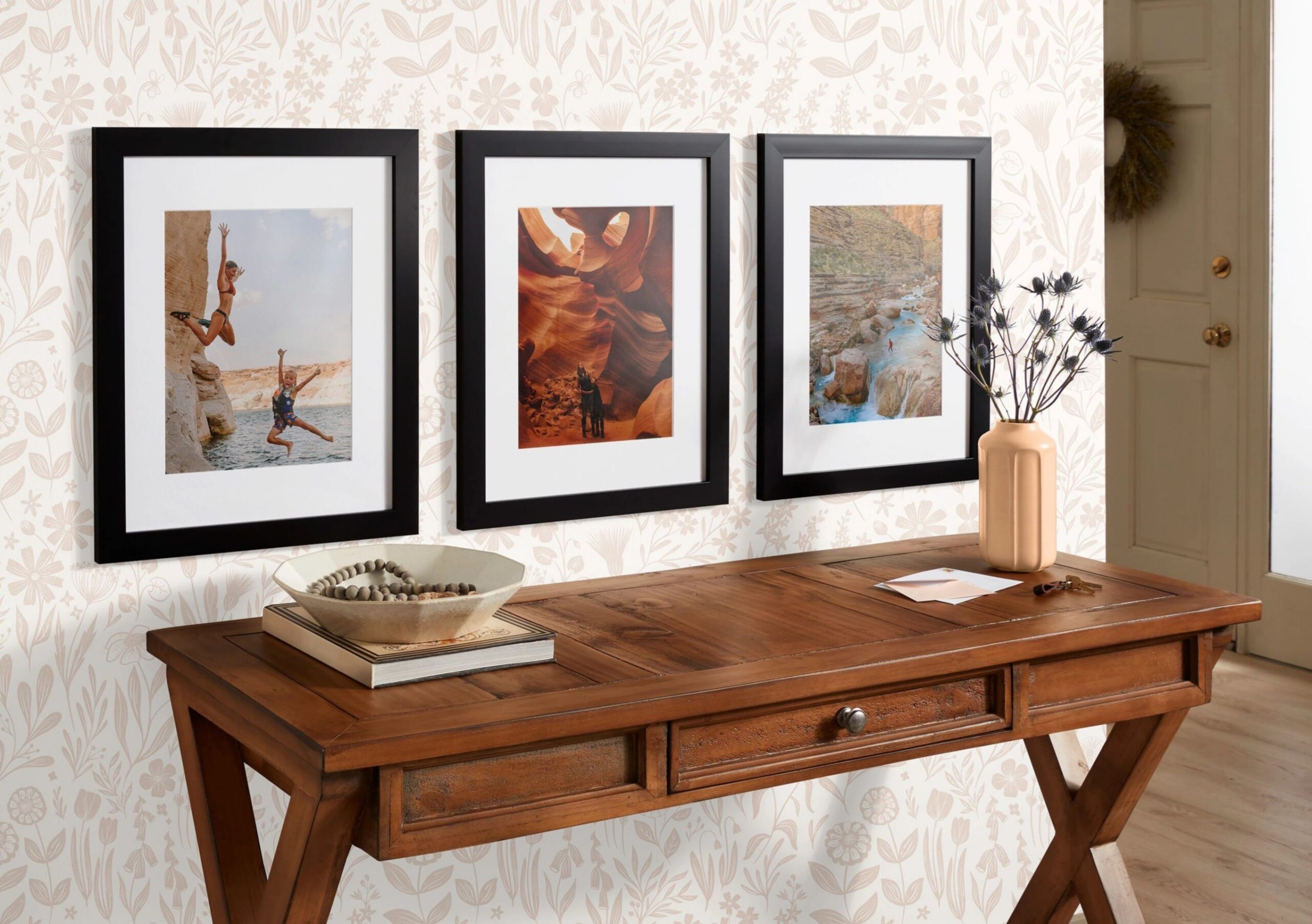 three framed prints with black frames hanging on wall with travel photos