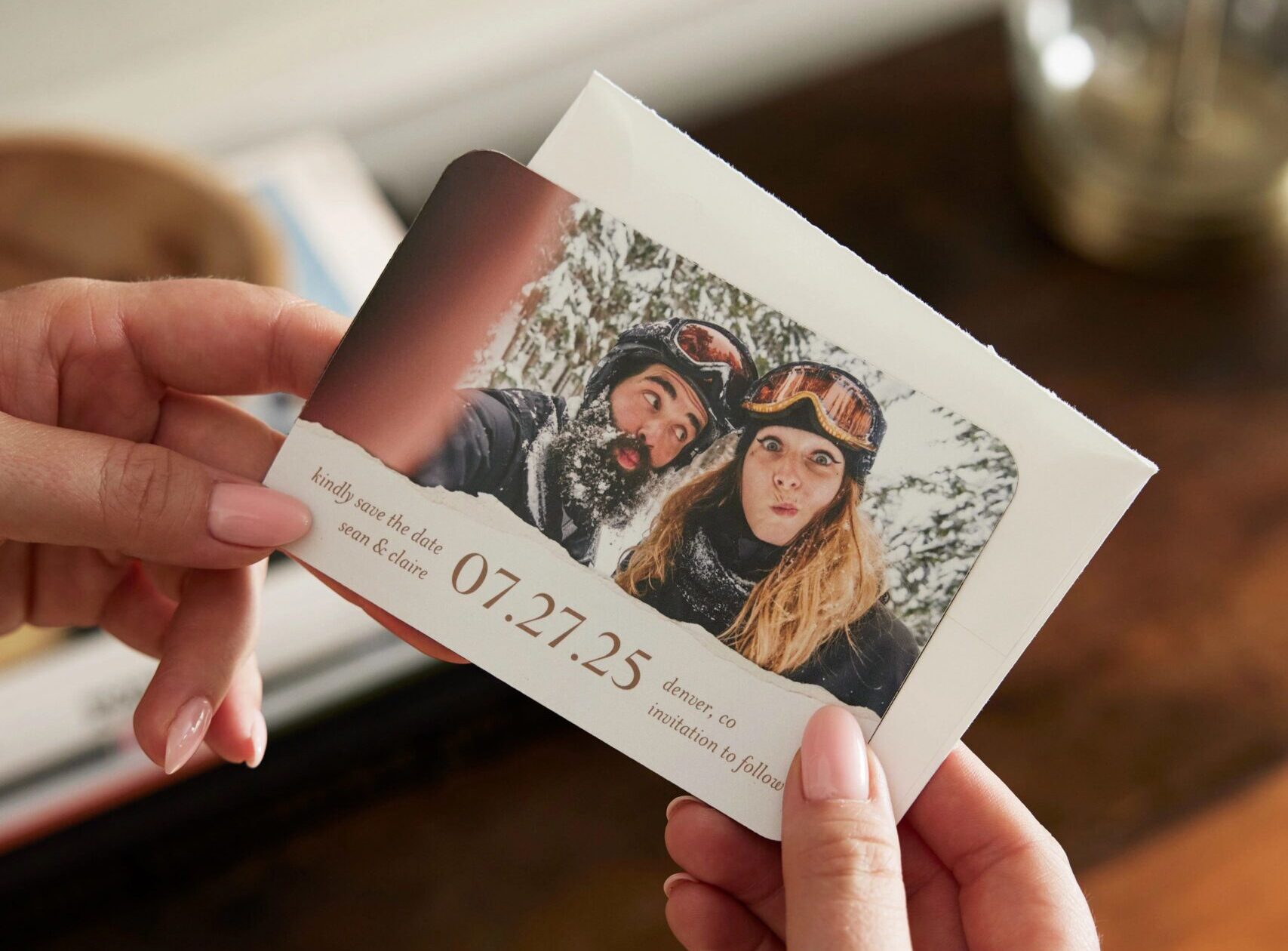 hands holding a save the date magnet