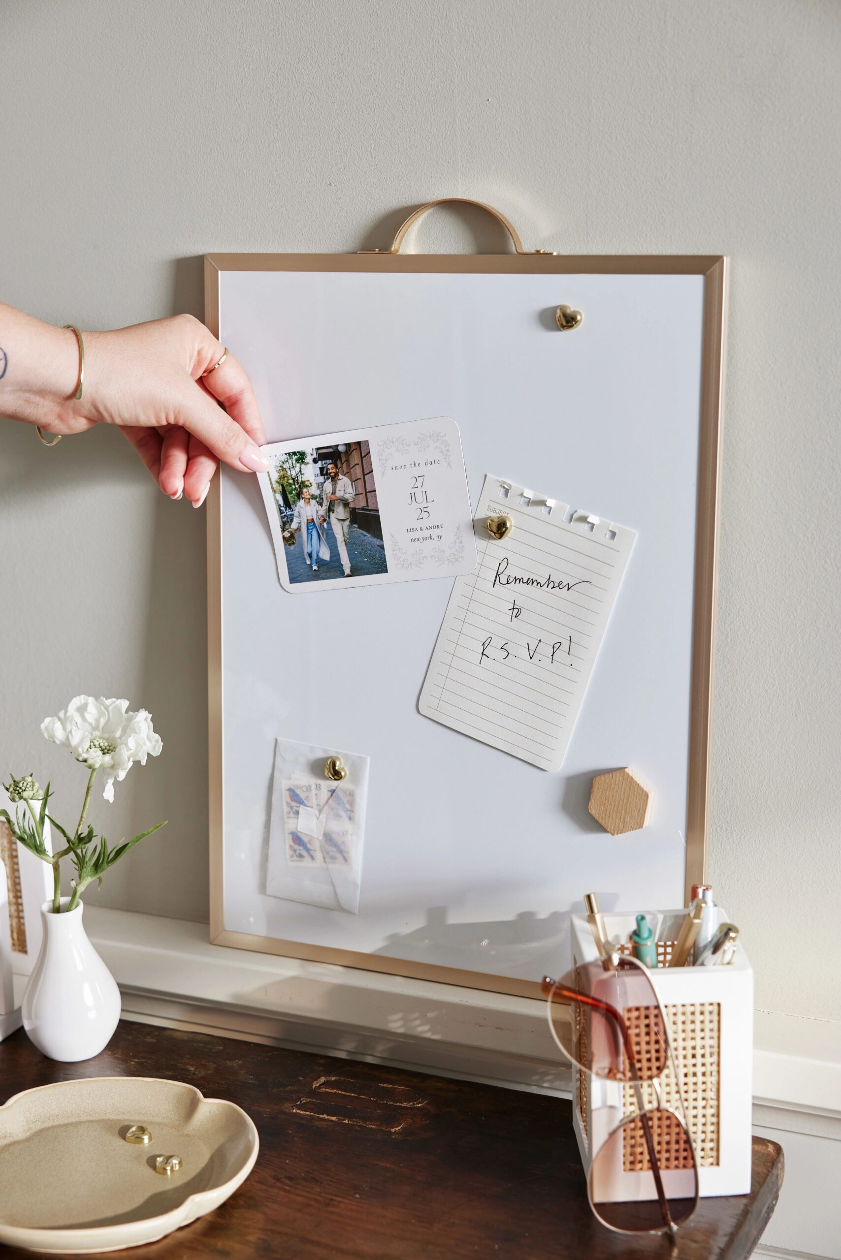 placing save the date magnet on a magnetic board
