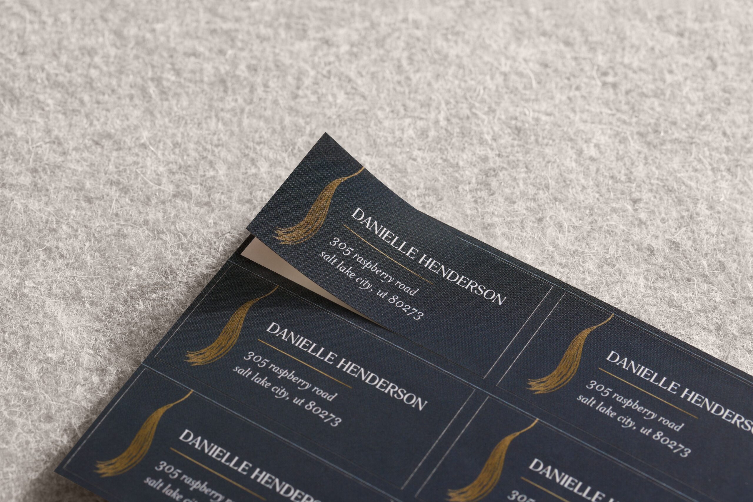 set of navy graduation address labels with a tassel design