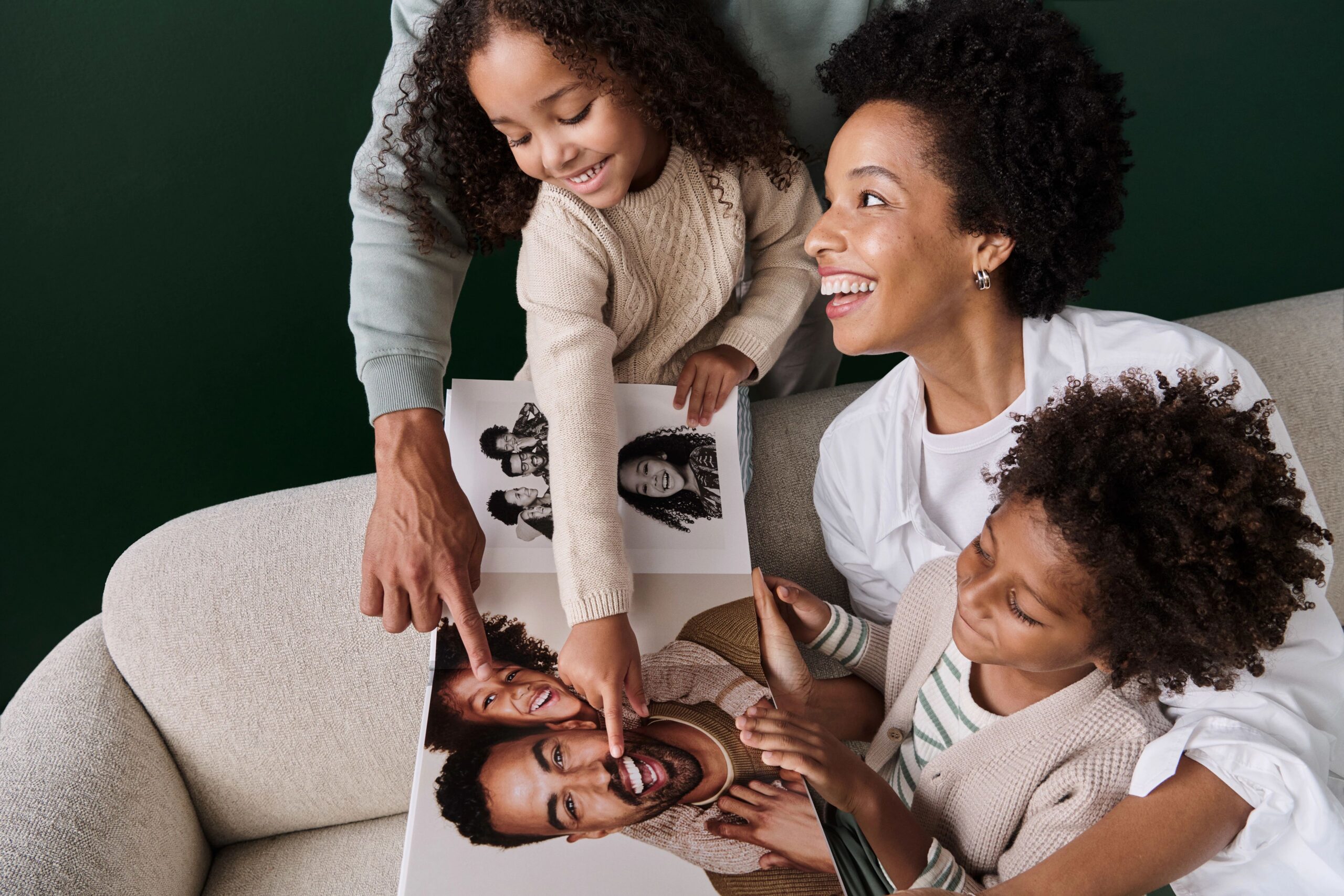 family flipping through 12x12 photo book