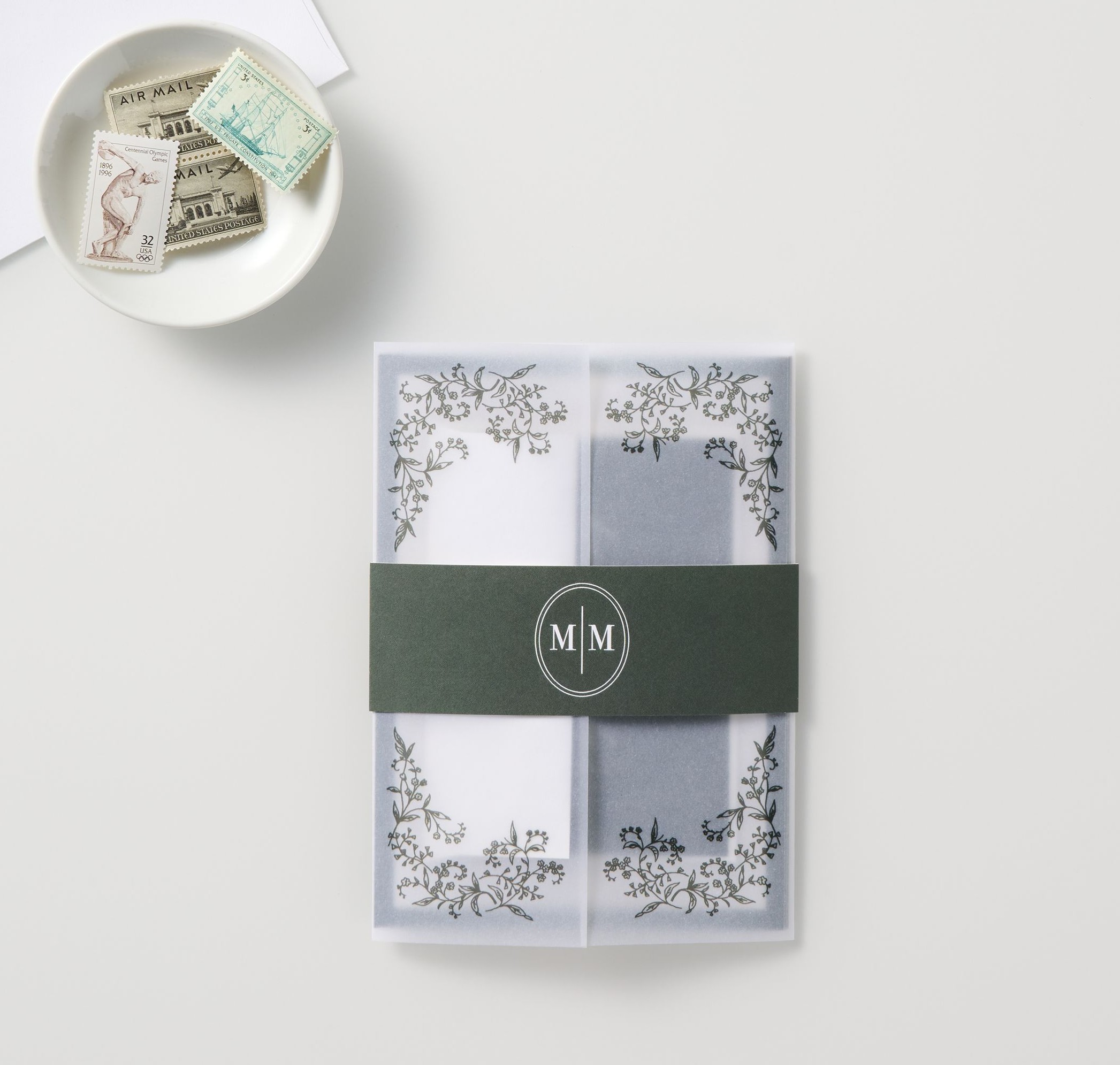 belly band holding vellum overlay, wedding invitation, and other wedding stationery