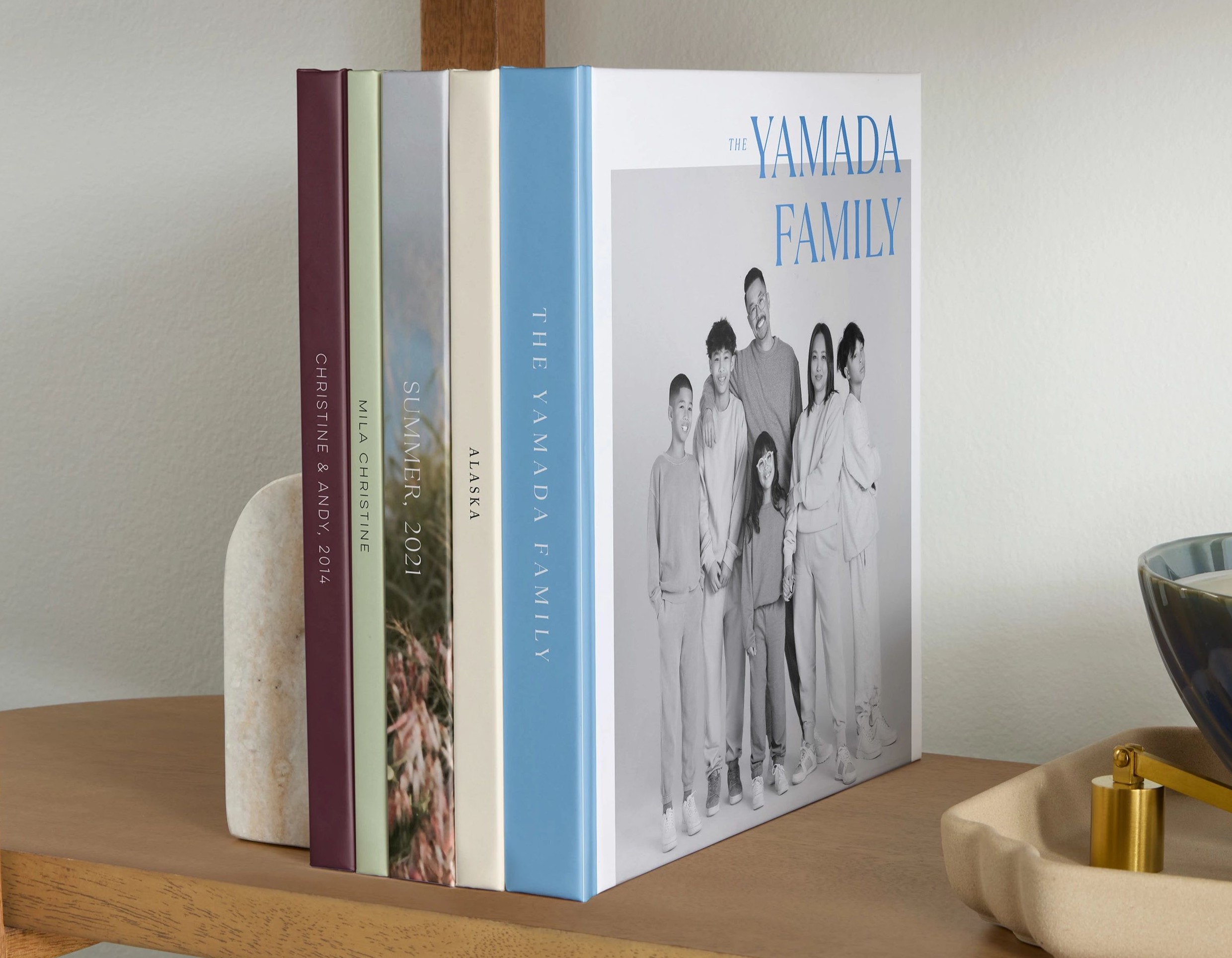 photo-wrapped and standard photo books displayed on a shelf