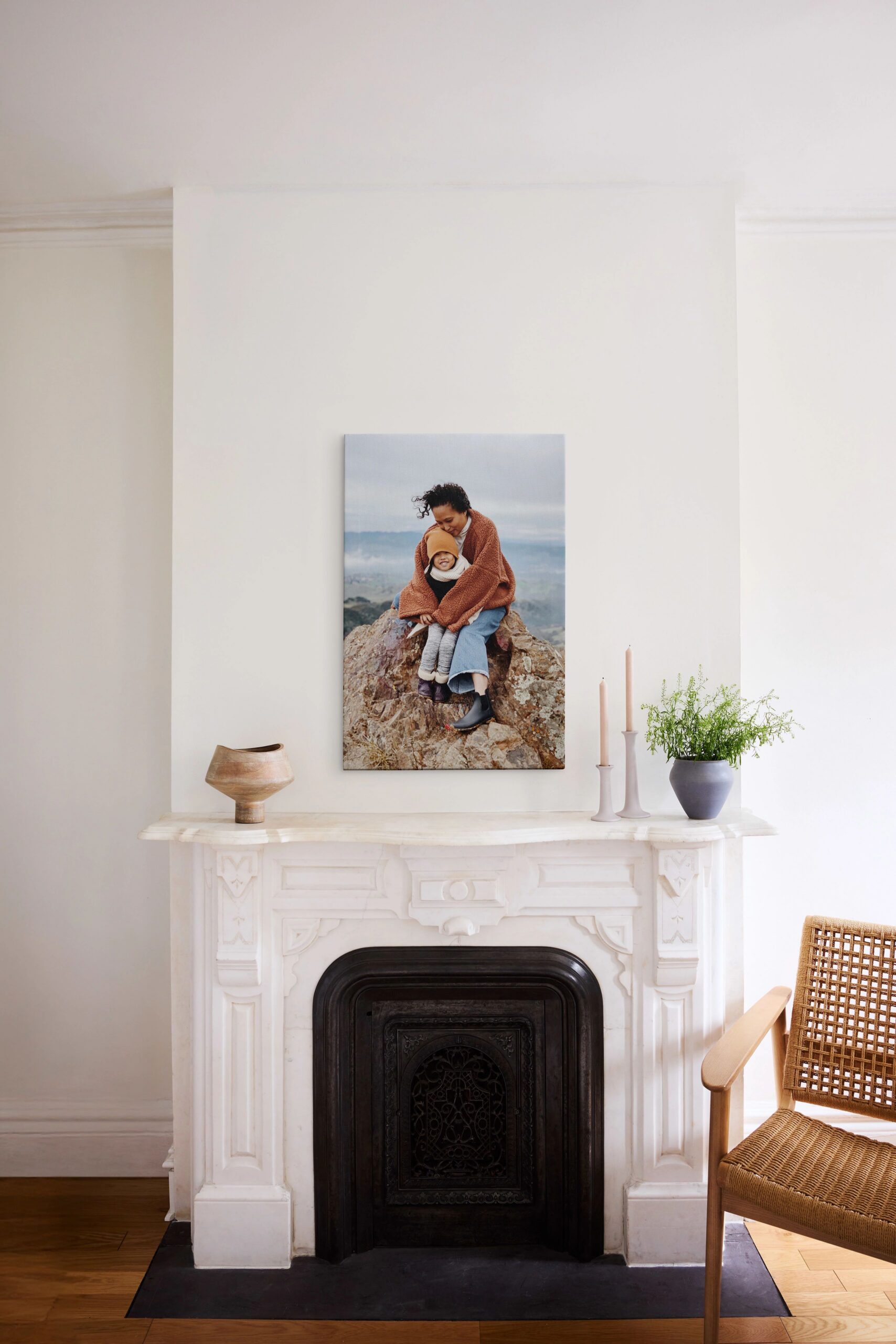unframed large canvas print hanging above fireplace