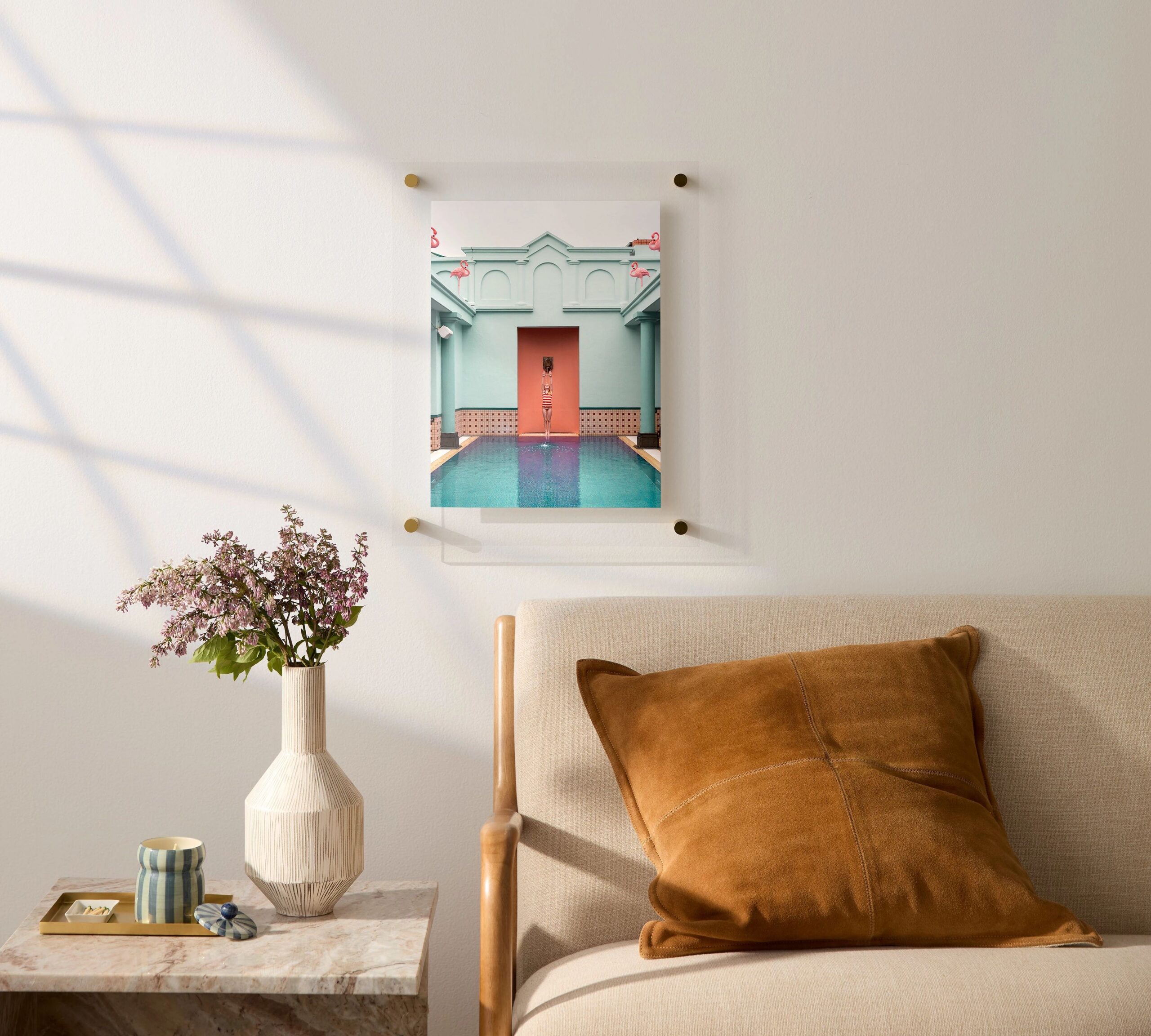 floating frame acrylic print hanging above a bed and nightstand