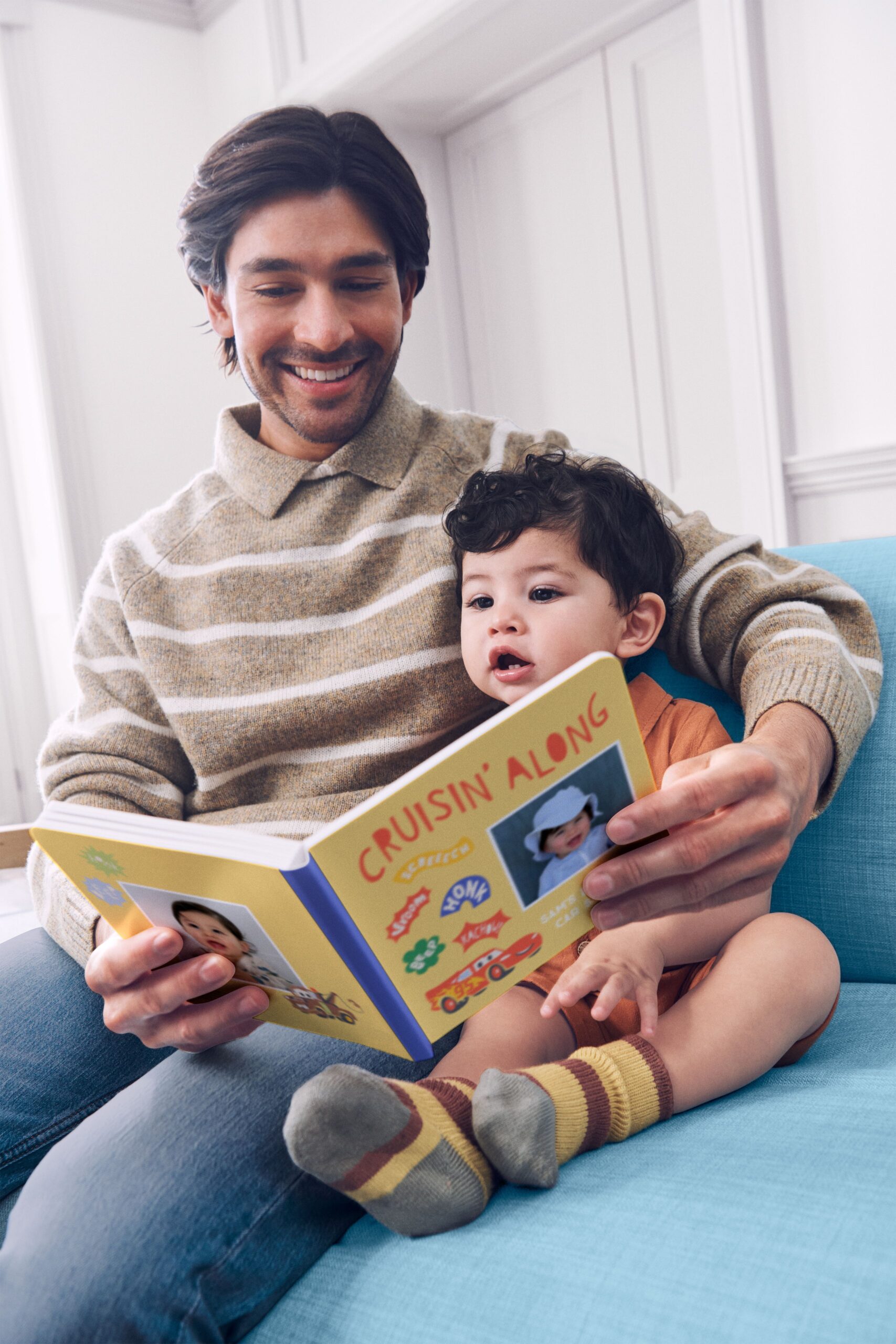 Father and son looking through a Disney board book