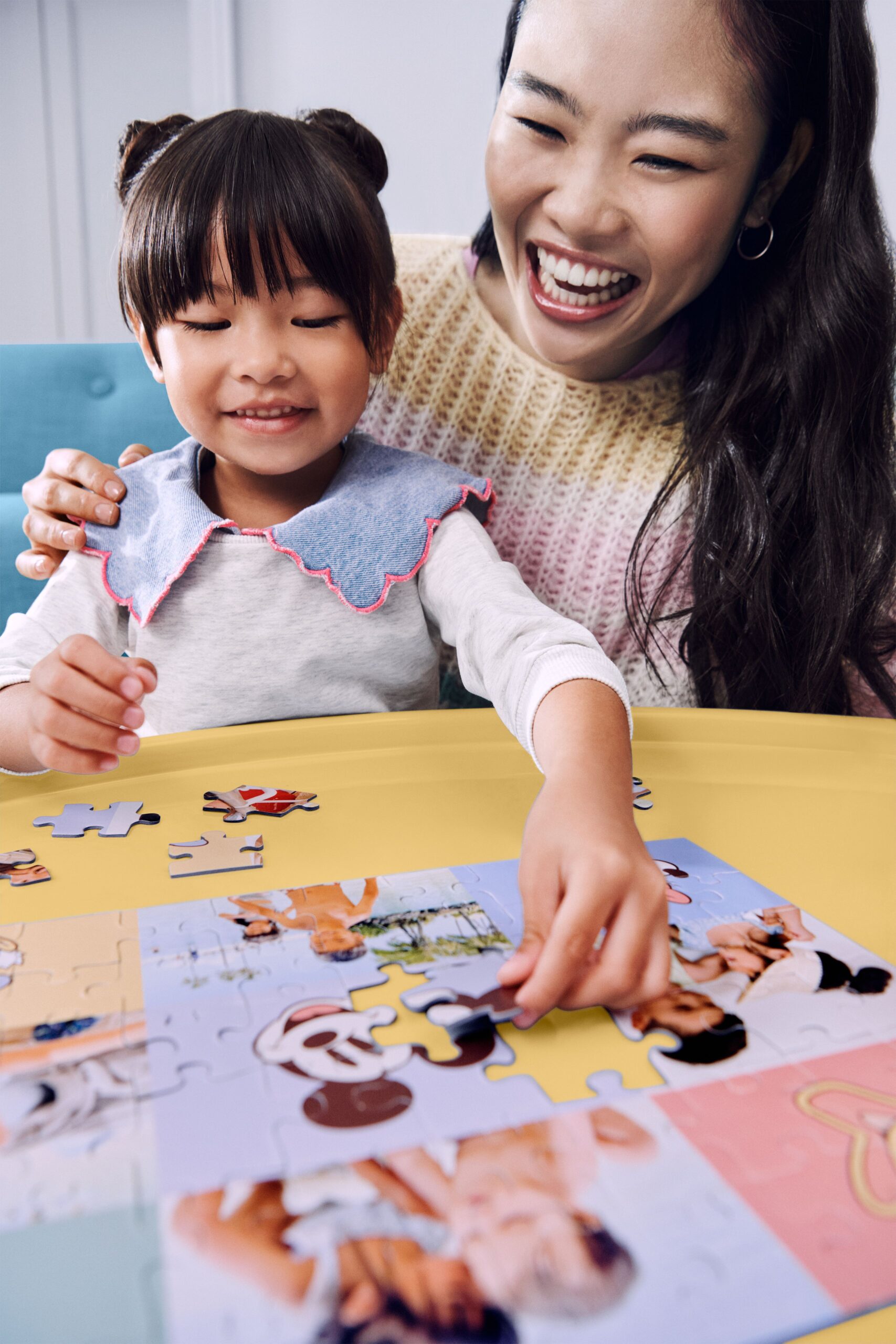 Mom and daughter putting together a Disney photo puzzle